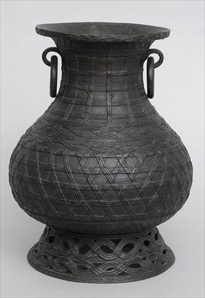 Appraisal: JAPANESE BRONZE FLOWER VASE With woven basket design and ring-drop