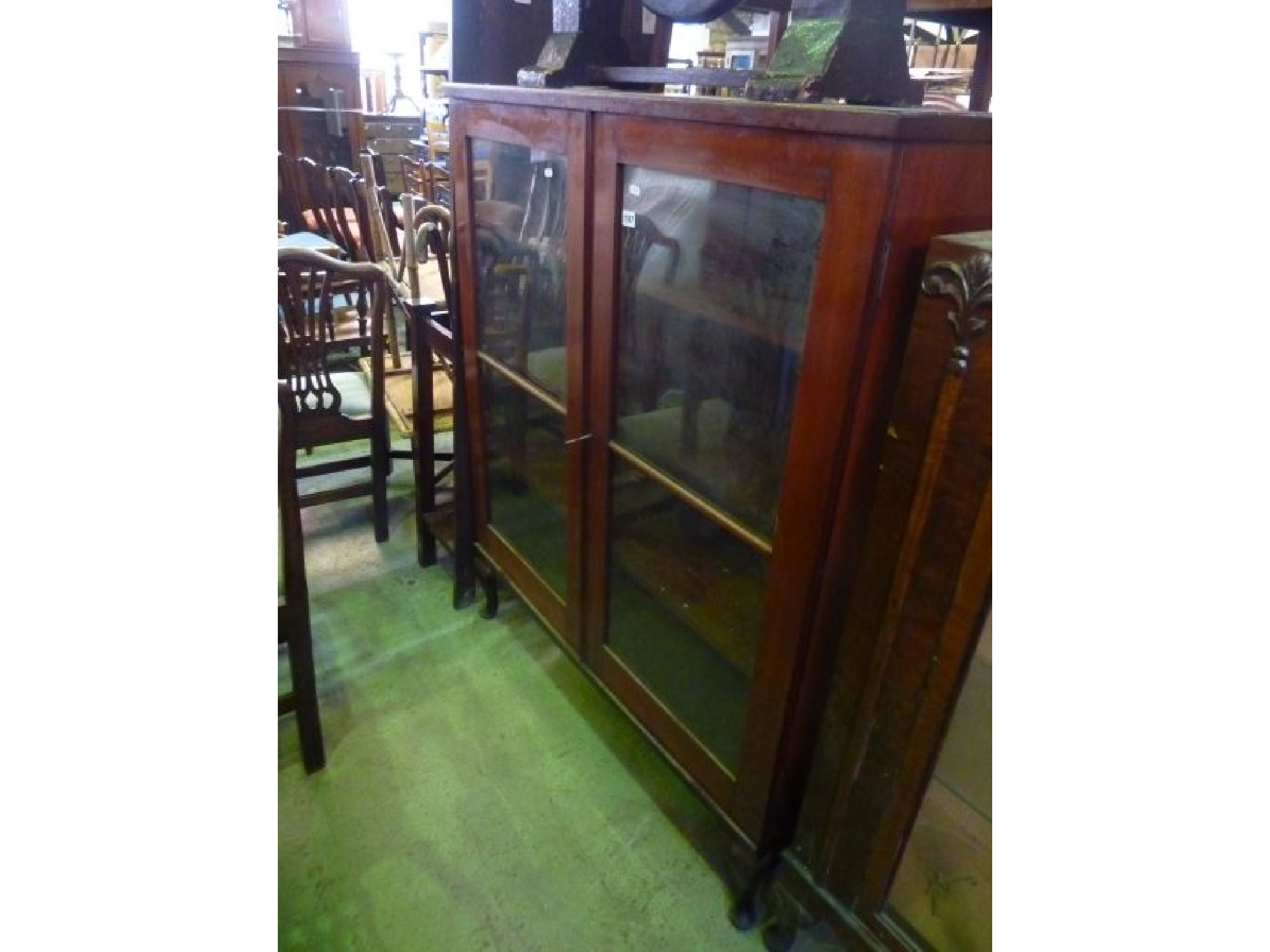 Appraisal: An Art Deco walnut veneered china display cabinet with etched