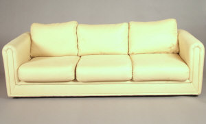 Appraisal: A cream upholstered three seater sofa th century the square