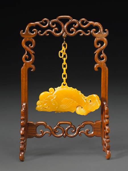 Appraisal: A yellow agate hanging pendant Republic Period Modeled as a