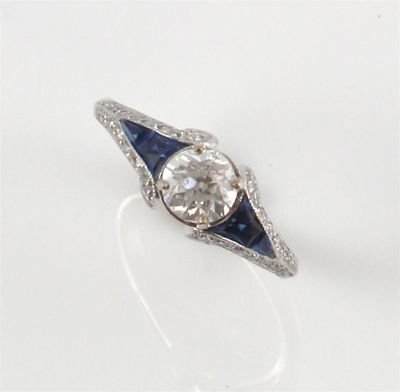 Appraisal: A diamond and sapphire ring The centre circular cut diamond