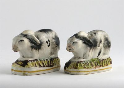 Appraisal: Two Staffordshire models of rabbits painted with black patches raised