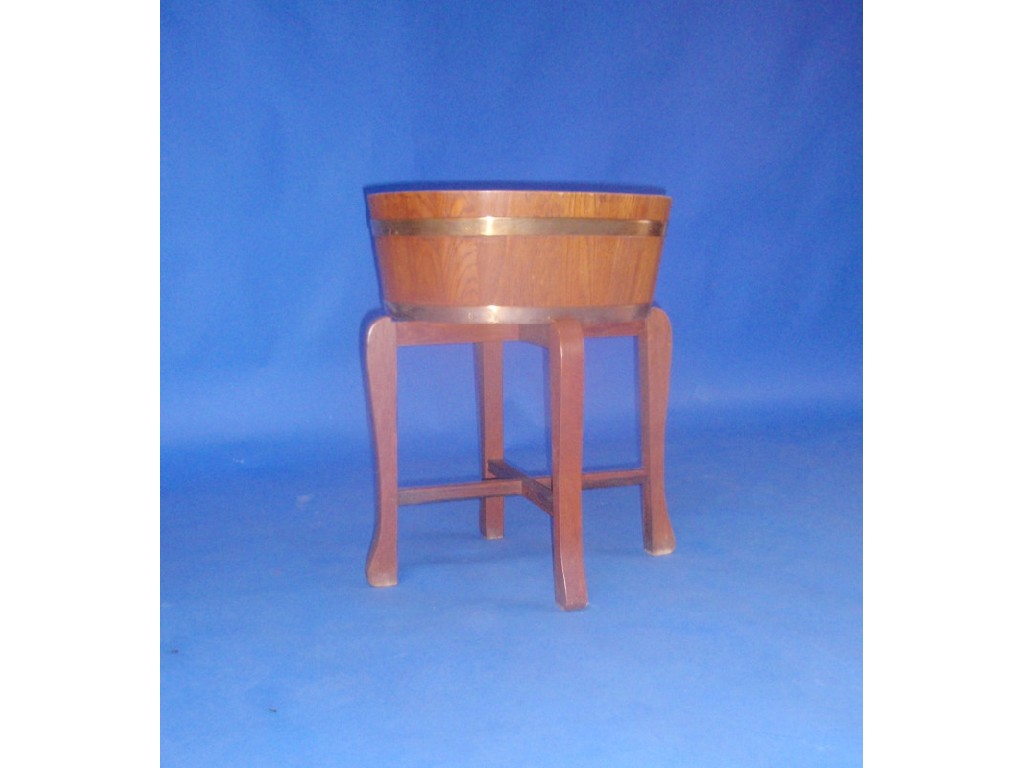 Appraisal: An oval oak jardiniere stand