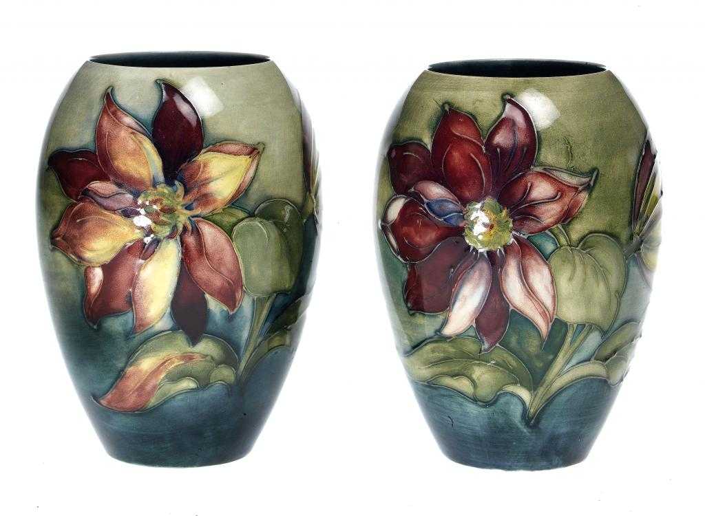 Appraisal: A PAIR OF MOORCROFT CLEMATIS VASES DESIGNED BY WILLIAM MOORCROFT