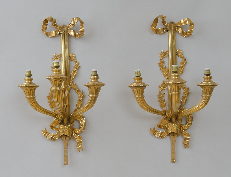 Appraisal: PAIR OF LOUIS XVI STYLE GILT-BRONZE THREE-LIGHT SCONCES Each bow-knotted