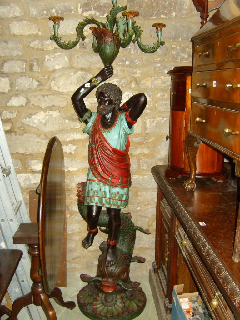 Appraisal: A floor standing -branch candelabra with blackamoor figure support with