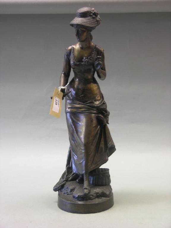 Appraisal: A bronzed spelter statuette figure of an Edwardian lady wearing