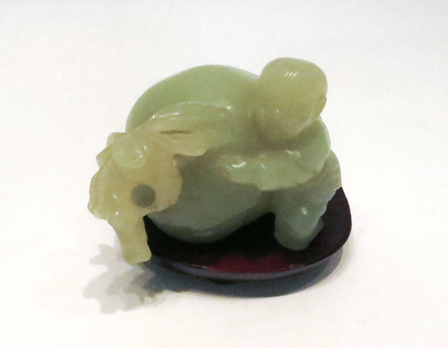 Appraisal: CHINESE CARVED GREEN JADE FIGURAL SCULPTURE a boy standing beside