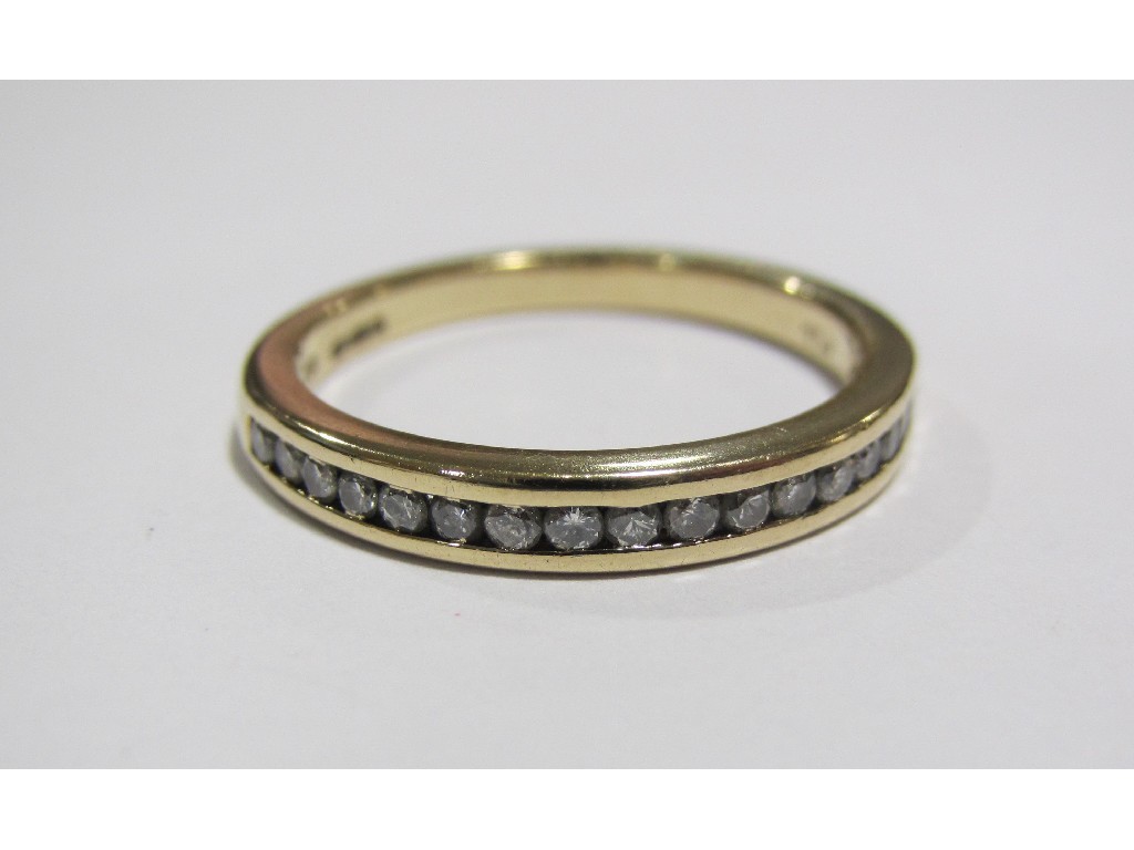 Appraisal: Eighteen carat gold channel set diamond half hoop ring