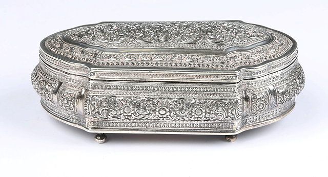 Appraisal: AN INDIAN SILVER BOX with repouss foliate decoration shaped sides