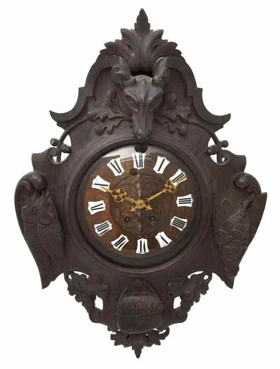 Appraisal: A Black Forest Carved Wood Clock the circular dial with