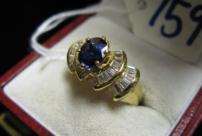 Appraisal: SAPPHIRE DIAMOND AND FOURTEEN KARAT GOLD RING centering an oval-cut