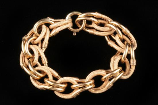 Appraisal: K YELLOW GOLD FLEXIBLE LINK BRACELET Textured and bright-polished triple-loop