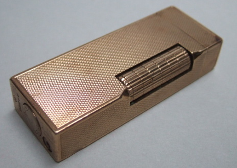 Appraisal: A ct yellow gold Dunhill lighter engine turned London