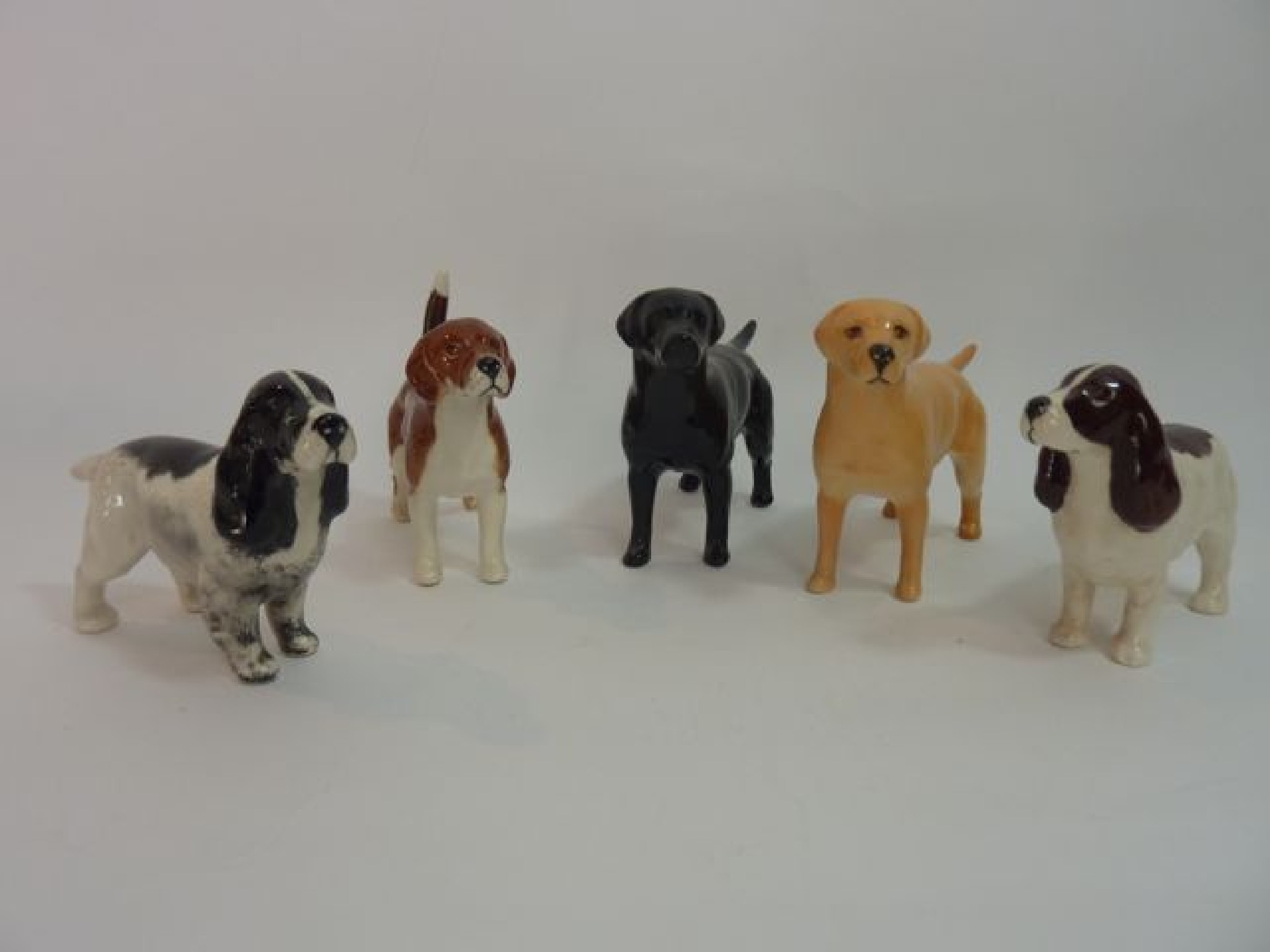 Appraisal: A collection of five Beswick model dogs comprising a yellow