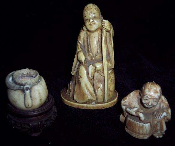 Appraisal: A Japanese ivory okimono of a seated man a cooking