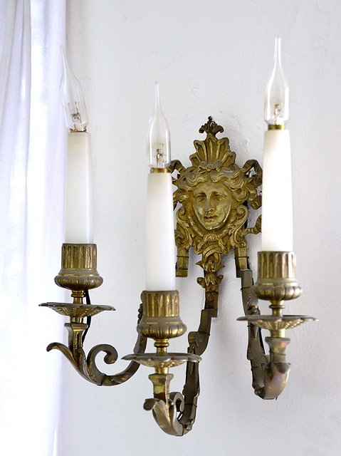 Appraisal: A GILT METAL THREE BRANCH WALL LIGHT with espagnolette head