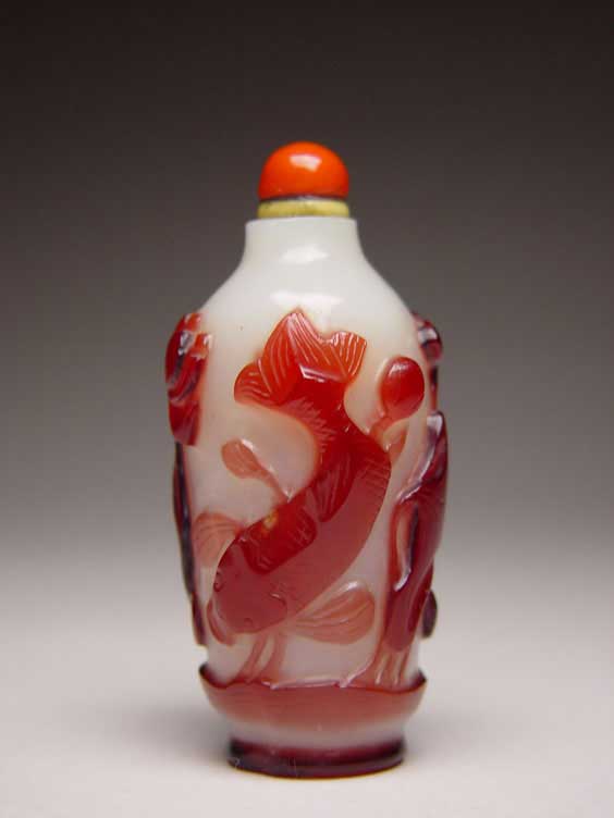 Appraisal: ANTIQUE OVERLAY GLASS SNUFF BOTTLE Antique carved red overlay on