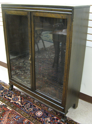 Appraisal: DARK OAK CABINET BOOKCASE American early th century having two