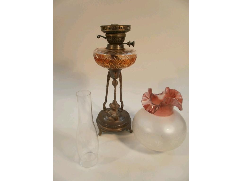 Appraisal: A Victorian oil lamp with cut glass reservoir and a