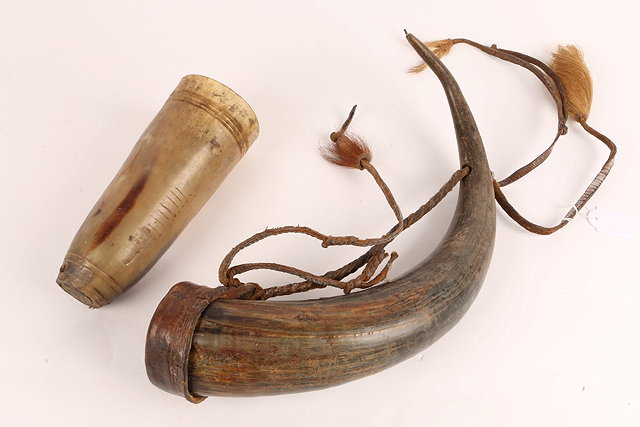 Appraisal: A MASAI HORN with leather cover and hair top knot