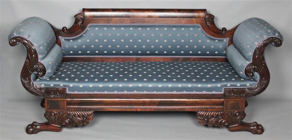 Appraisal: AMERICAN CLASSICAL CARVED MAHOGANY SOFA having a straight crest rail