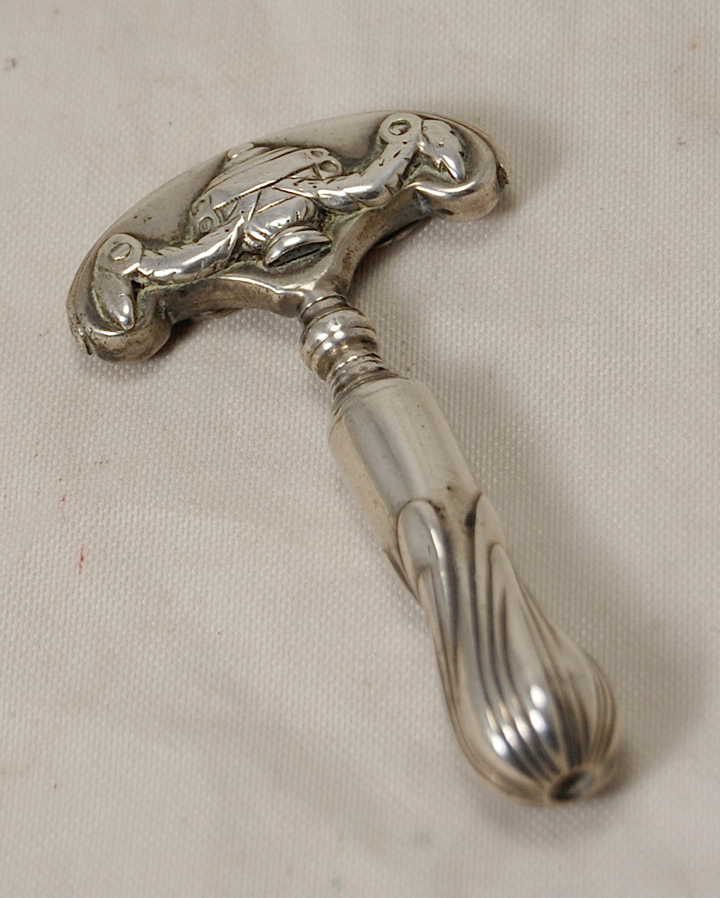 Appraisal: A Continental white metal scent-bottle corkscrew with cover