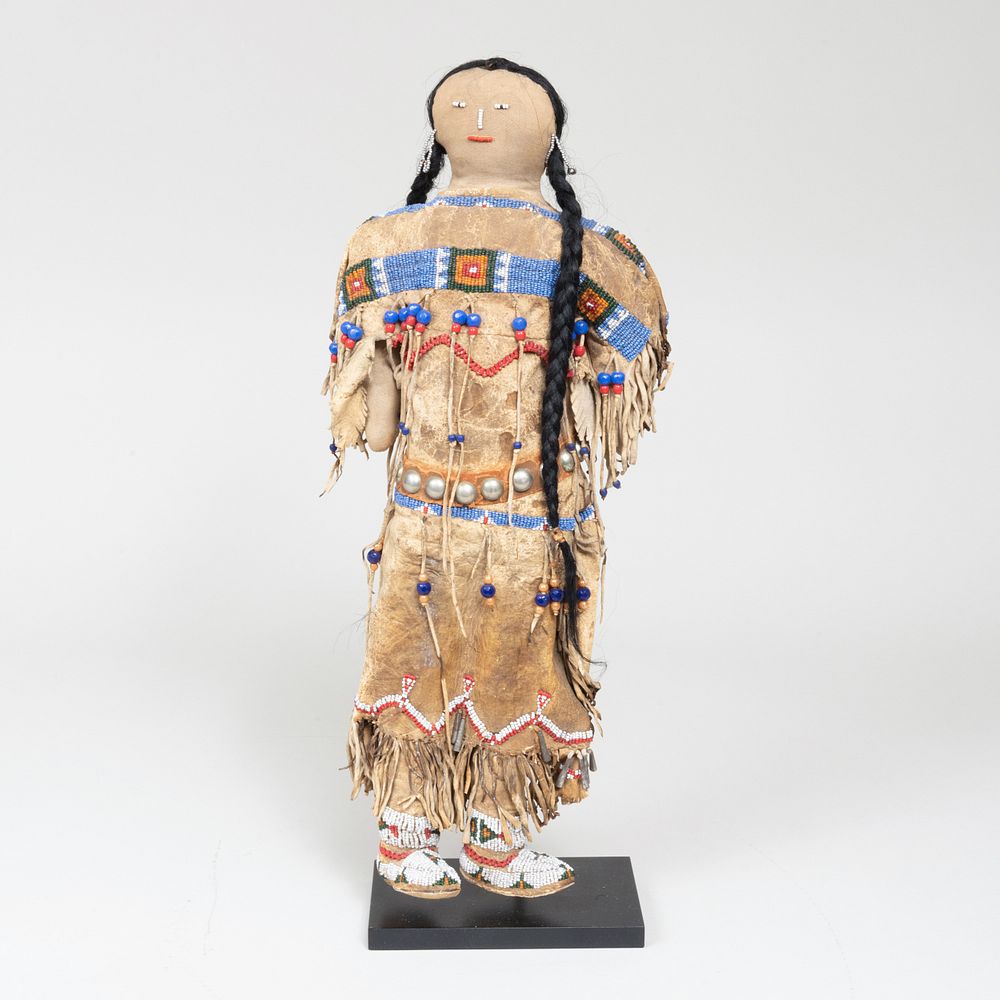 Appraisal: Plains Beaded Hide and Metal Doll Raised on a stand