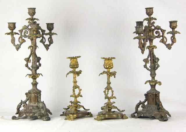 Appraisal: A pair of gilt and patinated metal four-light candelabra cm