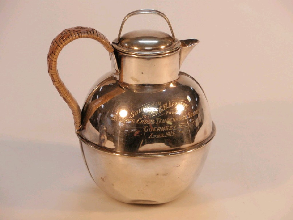 Appraisal: An electroplate globular jug and cover with wicker wrapped handle