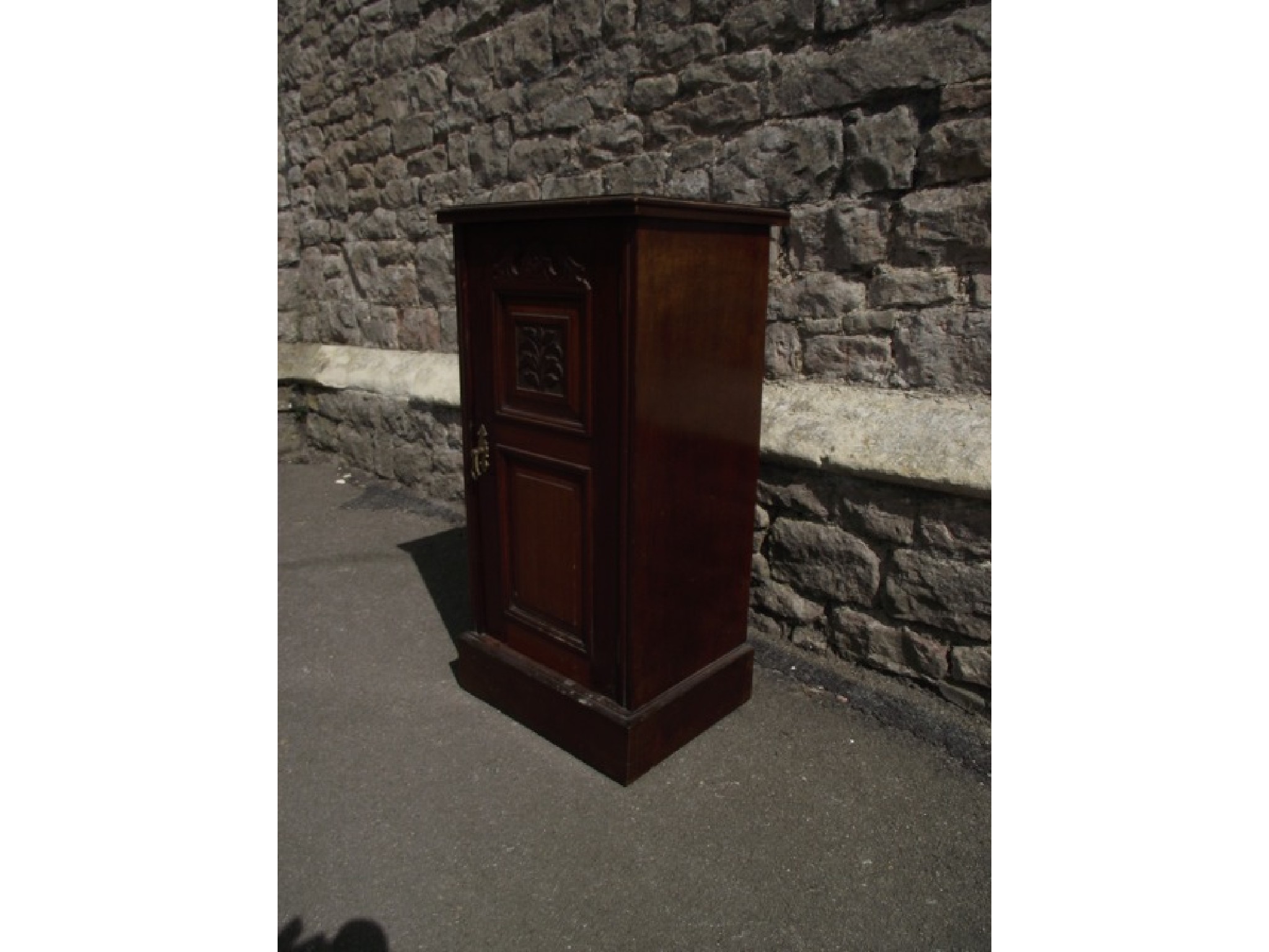 Appraisal: A late Victorian mahogany bedside cupboard enclosed by a panelled