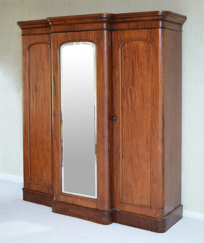 Appraisal: WALNUT SECTION ARMOIRE In sections middle section larger with beveled