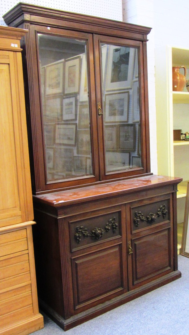 Appraisal: A late th century walnut bookcase with a pair of