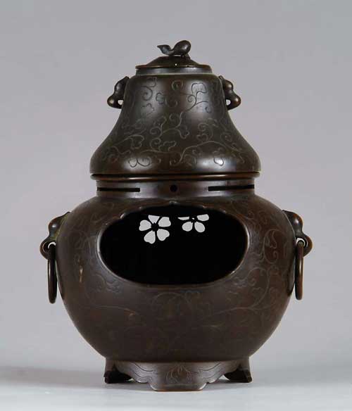 Appraisal: TWO PART COVERED INCENSE BURNER The bottom section with chased