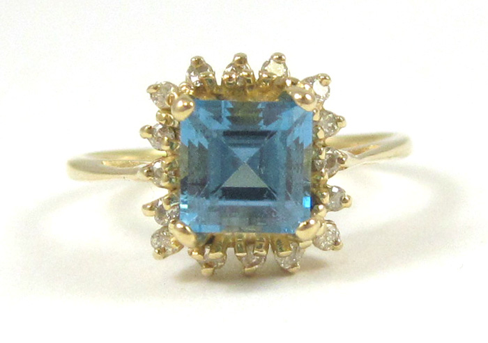 Appraisal: BLUE TOPAZ AND DIAMOND RING k yellow gold with round-cut