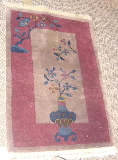 Appraisal: CHINESE MAUVE RUG DEPICTING A VASE AND FLOWER x Feet