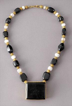 Appraisal: Jet and Gold Square Pendant on a Strand of Jet