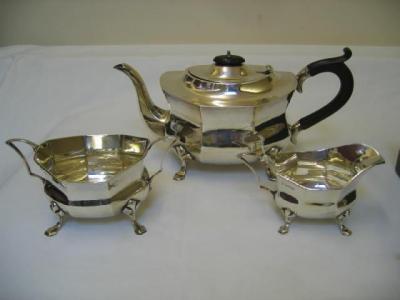 Appraisal: A THREE PIECE TEA SET of waisted oval panelled form