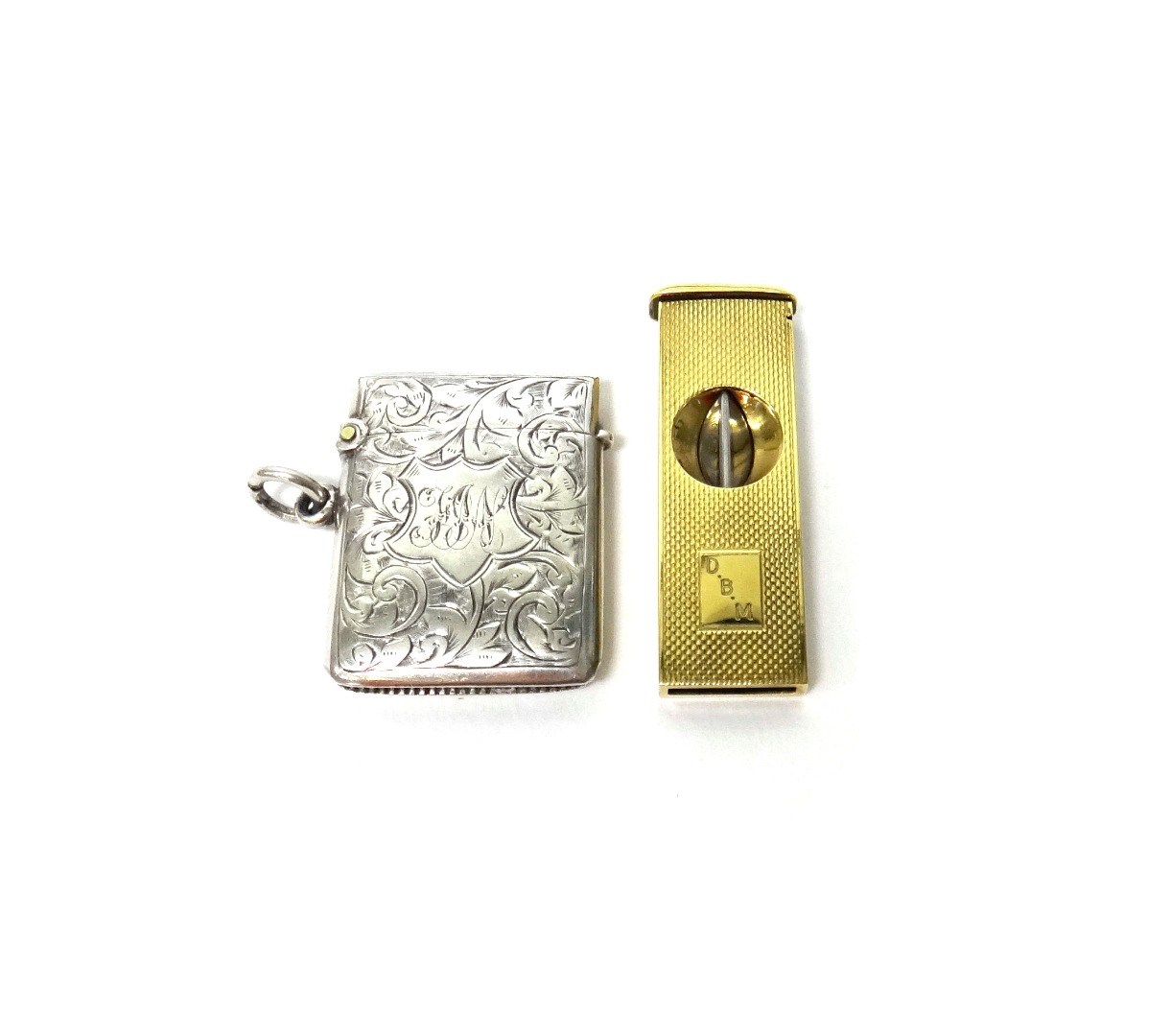 Appraisal: A ct gold cased rectangular slide action cigar cutter with