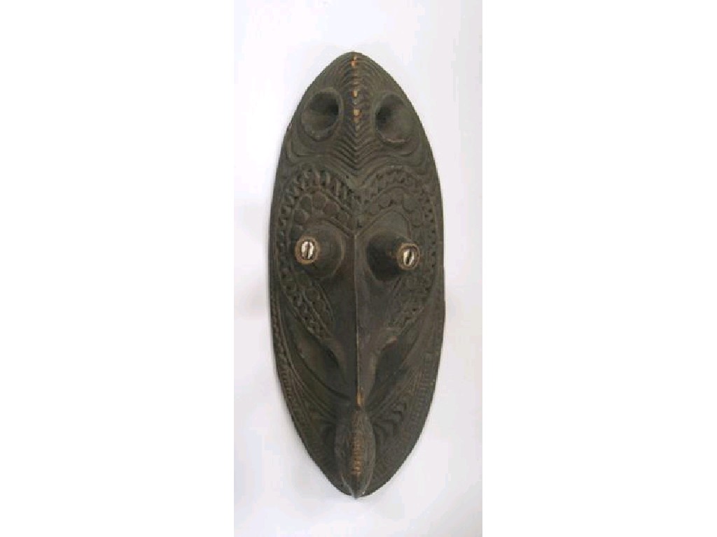 Appraisal: ETHNOGRAPHICA AN OCEANIC MASK with cowry shell nostrils and eyes