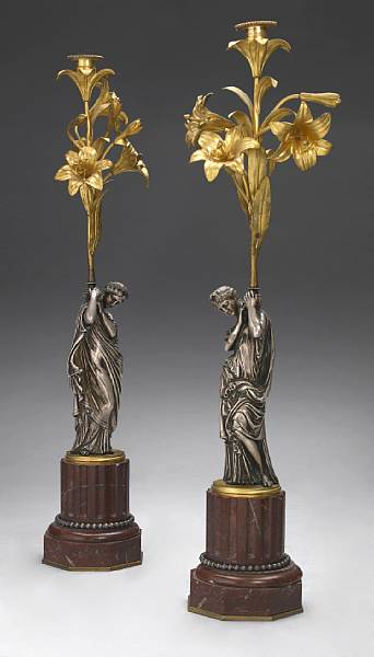 Appraisal: A pair of French gilt and silvered bronze figural candelabra