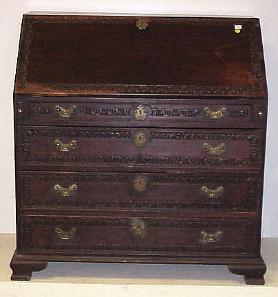 Appraisal: Slant lid desk with four drawers bas relief carving around