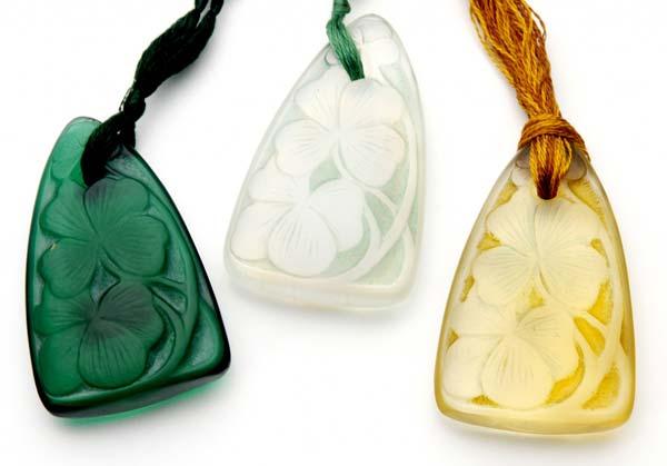 Appraisal: RENE LALIQUE Three Trefles pendants in opalescent yellow-amber and dark