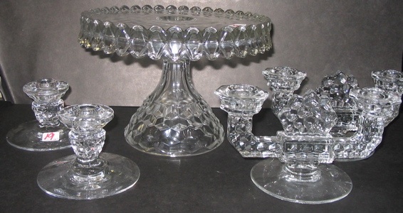 Appraisal: A FOSTORIA GLASS CAKE PLATE AND TWO PAIR OF CANDLEHOLDERS