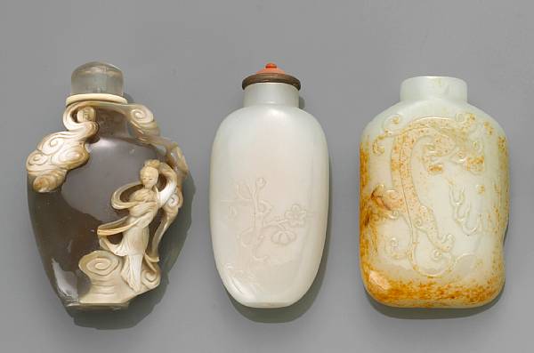 Appraisal: One agate and two white jade snuff bottles The first