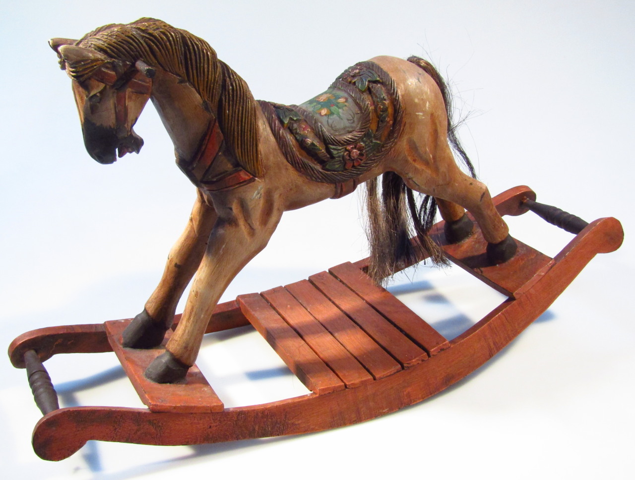 Appraisal: A thC style table top rocking horse heavily carved on