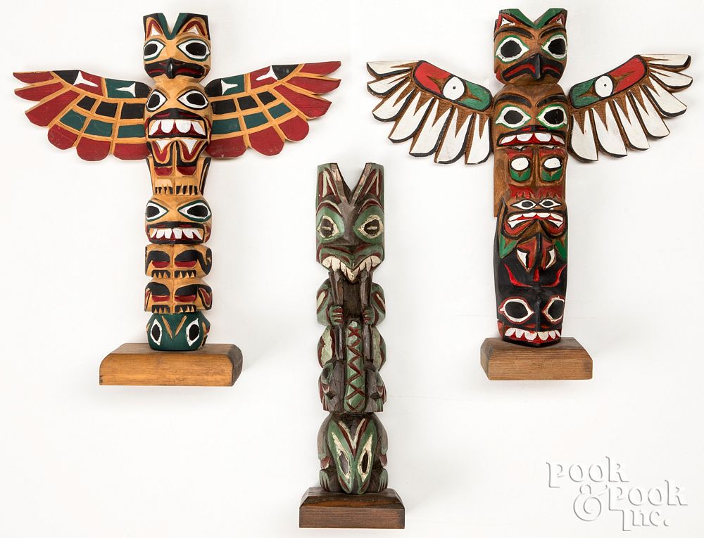 Appraisal: Northwest Coast carved and painted totem poles Northwest Coast Indian