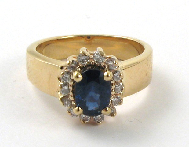 Appraisal: SAPPHIRE DIAMOND AND FOURTEEN KARAT GOLD RING centering a dark