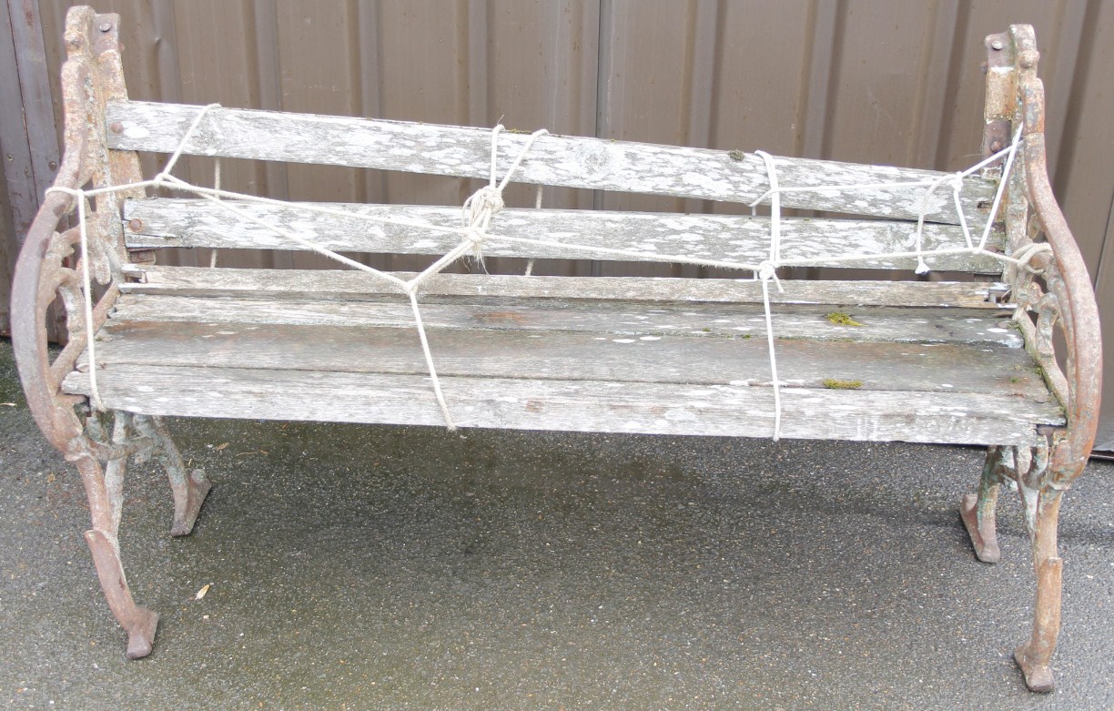 Appraisal: A cast iron and wooden garden bench the slatted back