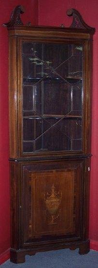 Appraisal: An Edwardian mahogany corner cupboard with moulded cornice the top